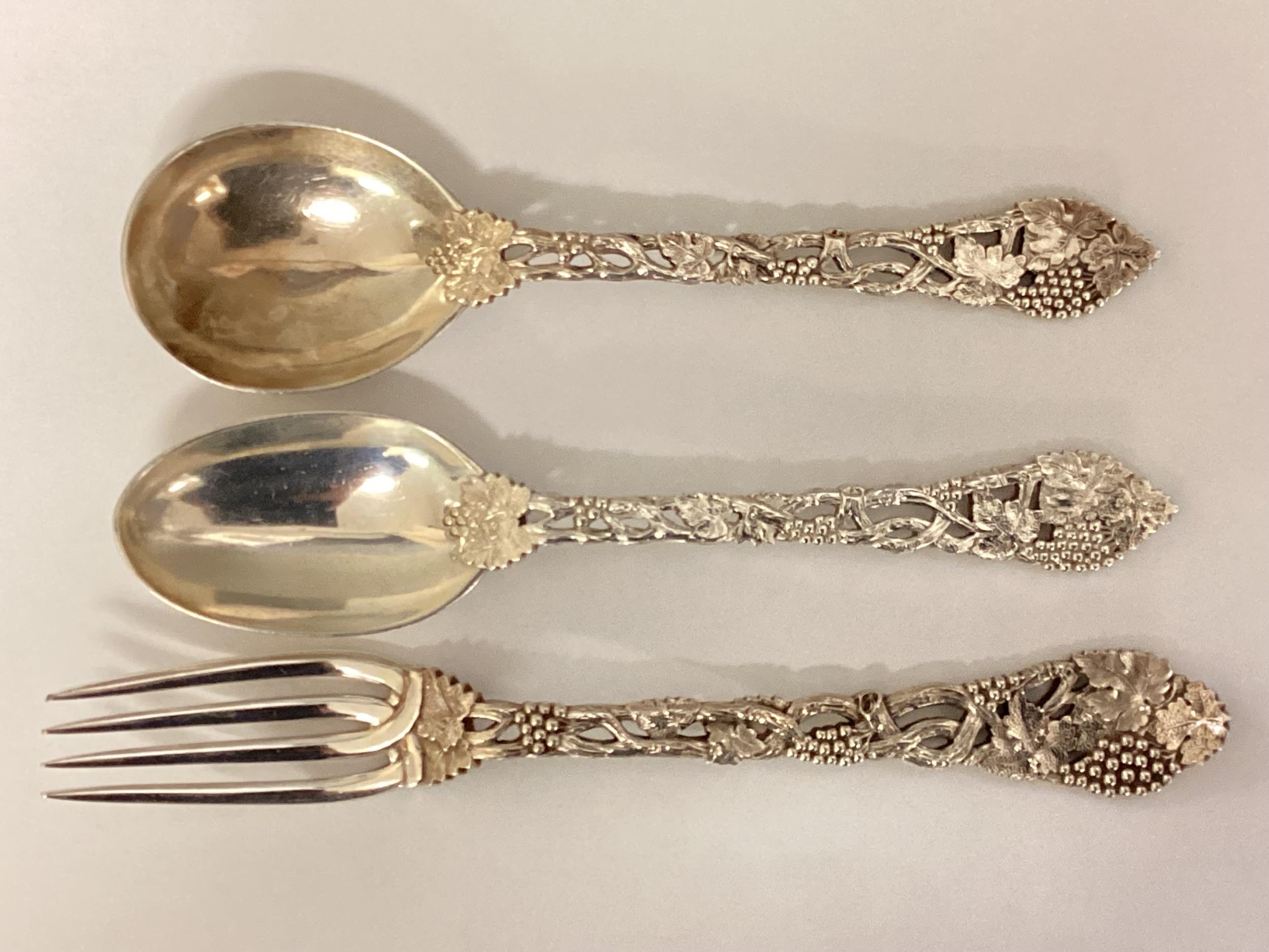 A set of three items of sterling silver cutlery. Plain bowls with cast leaf and vine stems. CJ