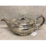 A sterling silver tea pot ,squat bulbous form with half reeded decoration possibly William Ely.