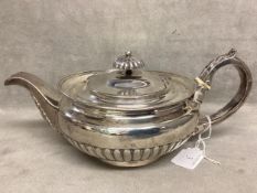 A sterling silver tea pot ,squat bulbous form with half reeded decoration possibly William Ely.