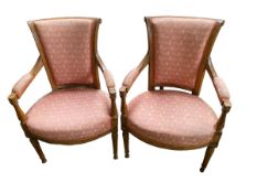 A pair of fruit wood framed arm chairs with pink upholstered seats and back and arm pads, some wear