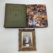 A collection of late 19th early 20th century postcard in two albums, and a picture