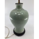 Chinese style green ceramic lamp base, with brass fittings for bulbs, on hardwood stand