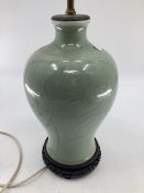 Chinese style green ceramic lamp base, with brass fittings for bulbs, on hardwood stand