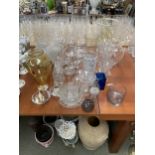 A good quantity of glass wares to include glass vases, candle sticks, glass candle holders, jugs and