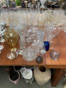 A good quantity of glass wares to include glass vases, candle sticks, glass candle holders, jugs and