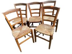 Set of 5 small elm country chairs with rush seats, some wear to cane work, and a black and gilt