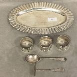 A collection of silver items to include napkin rings, christening set, Mexico silver oval tray.