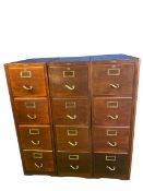 Three modern dark wood four drawer filing cabinets, with brass name plates and handles