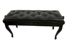 A black duet piano stool, with black buttoned leather seat, and adjustable knob