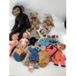 A collection of dolls and vintage cuddly toys