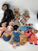 A collection of dolls and vintage cuddly toys