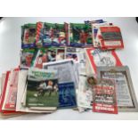 A collection of football programmes, Swindon, Tottenham together with enamel club badges WBA, Oxford