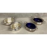 A set of four sterling silver salts, two with blue glass liners. Various dates and makers Silver