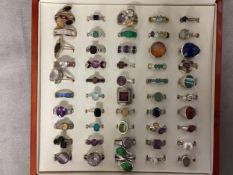 A collection of 925 silver rings all gem or paste set in a presentation box. 50 in total