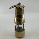 A brass miners lamp. The Protector. 24cm(h)