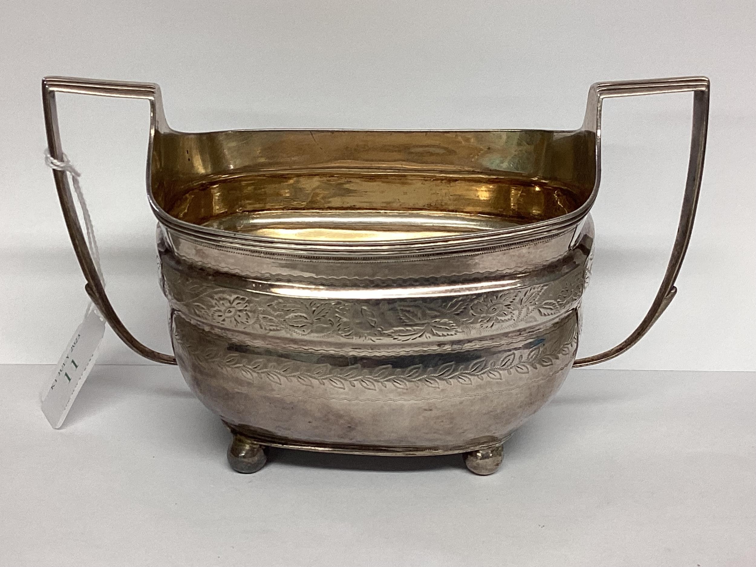 A Georgian sterling silver sugar bowl with chased decoration . 253g London 1808.