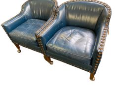Pair of blue studded leather small arm chairs on ball castors, some general wear.