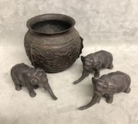 Three Oriental bronze elephants with cartouche stamp to base with a bronze oriental base.