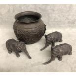 Three Oriental bronze elephants with cartouche stamp to base with a bronze oriental base.