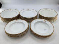 A Mintons China eight setting dining service with gilt border and monogram to centre, Retailed by