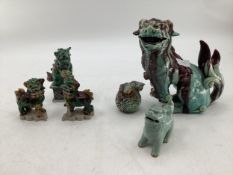 Six decorative ceramic figurines of Dogs of Fo, in a green and blue glaze, highest measuring 23cmH