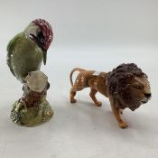 Two Beswick items, Woodpecker and Lion. Largest 23cm (h)