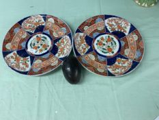 A pair of Japanese chargers in the Imari palette, approx 23 diameter, and a carved coconut in the