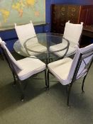 A Circular glass topped dining table with metal base, and four matching metal chairs, 110cm diameter