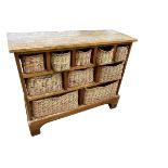 A modern kitchen side unit with cubby holes with wicker baskets, some wear to top etc; 104cmW x