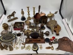 A collection of metal ware to include a pair of candle sticks, brass and copper items, a table