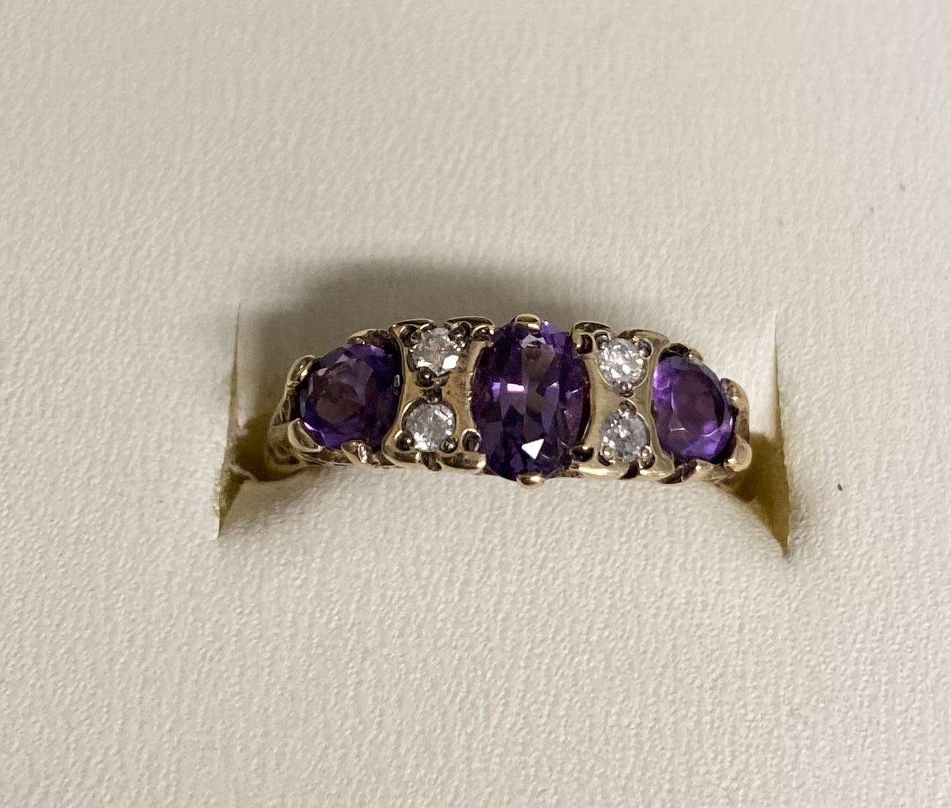 A 9ct gold amethyst and diamond ring. Three free cut amethysts with double brilliant cut diamond - Image 2 of 3