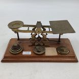 A set of early 20th century postal scales with related weights.