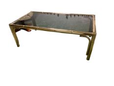 Modern brass and smoked glass coffee table, 118cn L x 63cmW; and a modern cream leather reclining
