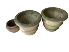 Two large weathered stone style garden planters and another smaller garden pot