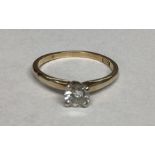 An 18ct gold single stone diamond ring. Brilliant cut diamond in a four claw setting. Diamond approx