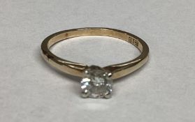 An 18ct gold single stone diamond ring. Brilliant cut diamond in a four claw setting. Diamond approx