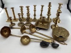 A collection of brass items to include 5 pairs of candlesticks, a 19th century go to bed, large