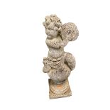 A weathered garden ornament, of a cherub on ball finial