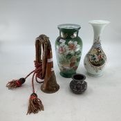 Two glass vases together with a military bugle and an Islamic style metal vase.
