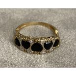 An unmarked yellow metal (hallmarks rubbed) sapphire and diamond ring. . Five free cut sapphires