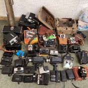 A large collection of C20th cameras, cine and a projector and screen. Quantity.