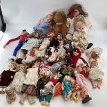A collection of dolls to include porcelain headed examples.