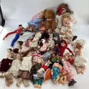 A collection of dolls to include porcelain headed examples.