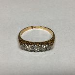 A 18ct gold and diamond ring. Five graduated old cut diamonds. 2.86g. Size N