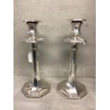 A Pair of sterling silver candlesticks of octagonal design, weighted bases. James Dixon and Son