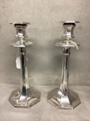 A Pair of sterling silver candlesticks of octagonal design, weighted bases. James Dixon and Son