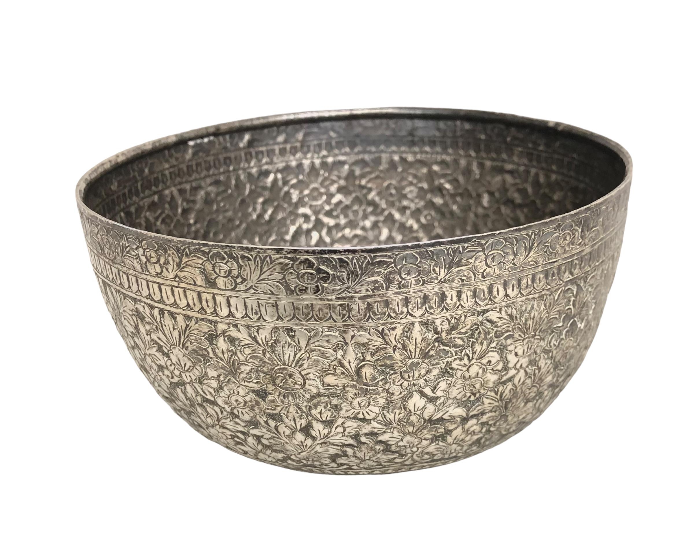 A South Asian white metal bowl with chased floral decoration. 13cm(d) 128g.