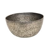 A South Asian white metal bowl with chased floral decoration. 13cm(d) 128g.