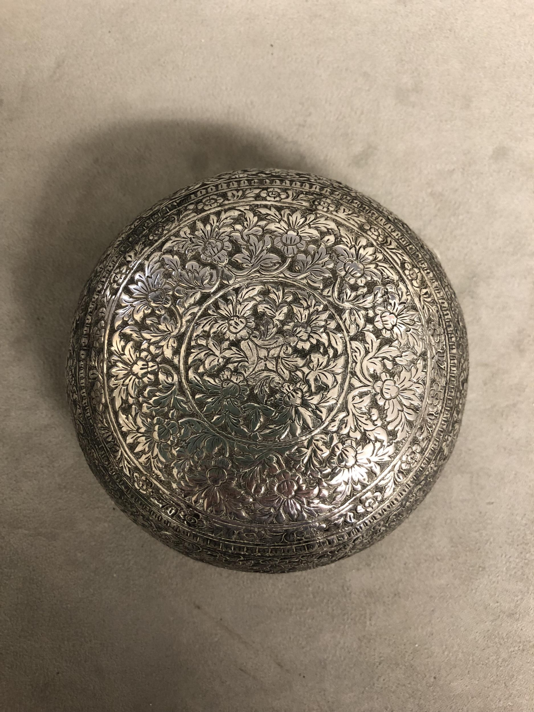 A South Asian white metal bowl with chased floral decoration. 13cm(d) 128g. - Image 2 of 4