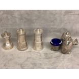 A collection of sterling silver items to include a cruet set and three pepper grinders.